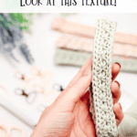 A hand holds a crocheted keychain made of light green yarn; assorted crafting materials and a crochet nesting trays pattern are blurred in the background. Text reads: "Look at this texture!.