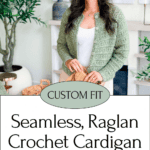 Woman wearing a green crochet cardigan stands indoors by a plant. Discover the seamless raglan crochet cardigan pattern—stylish, cozy, and perfect for any season. Find the pattern and more on our website!.