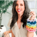 A woman smiles and holds up several colorful crochet scrunchies stacked on her arm. The text above her reads, "The cutest & easiest scrunchies!"—perfect for pairing with your latest crochet nesting trays pattern.