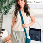 Woman stands indoors holding a crocheted water bottle holder with a shoulder strap; a water bottle is visible inside. Text reads "Water Bottle Holder Video Tutorial.