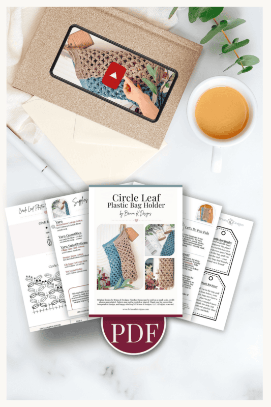 A flat lay showing a PDF crochet pattern for a circle leaf plastic bag holder, printed instruction sheets, an envelope with a tablet displaying a crochet tutorial, and a cup of coffee.