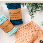 Three crocheted washcloths in pastel colors are displayed, two rolled with brown labels and one spread out, next to greenery on a white surface. Text above advertises a free crochet washcloth pattern.