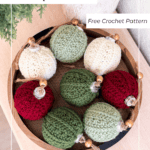 A wooden bowl holds seven crochet Christmas ornaments in red, green, and cream, each with a loop and wooden bead on top. Text reads "Petal Loop Ornament Free Crochet Pattern.