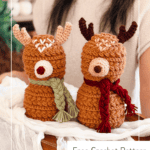 Two crocheted reindeer amigurumi with scarves and antlers are displayed on a table. Text reads: "Reindeer Amigurumi, Free Crochet Pattern, www.brianakdesigns.com".