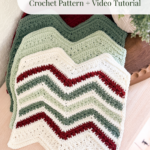 Four crocheted chevron washcloths in green, white, and red tones are stacked on a wooden surface beside a plant. Text above them advertises a crochet pattern and video tutorial.