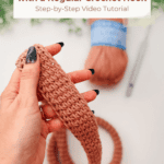 A hand holds a crocheted strap in progress with a ball of yarn, crochet hook, and scissors in the background. Text overlay describes a Tunisian Simple Stitch strap tutorial.