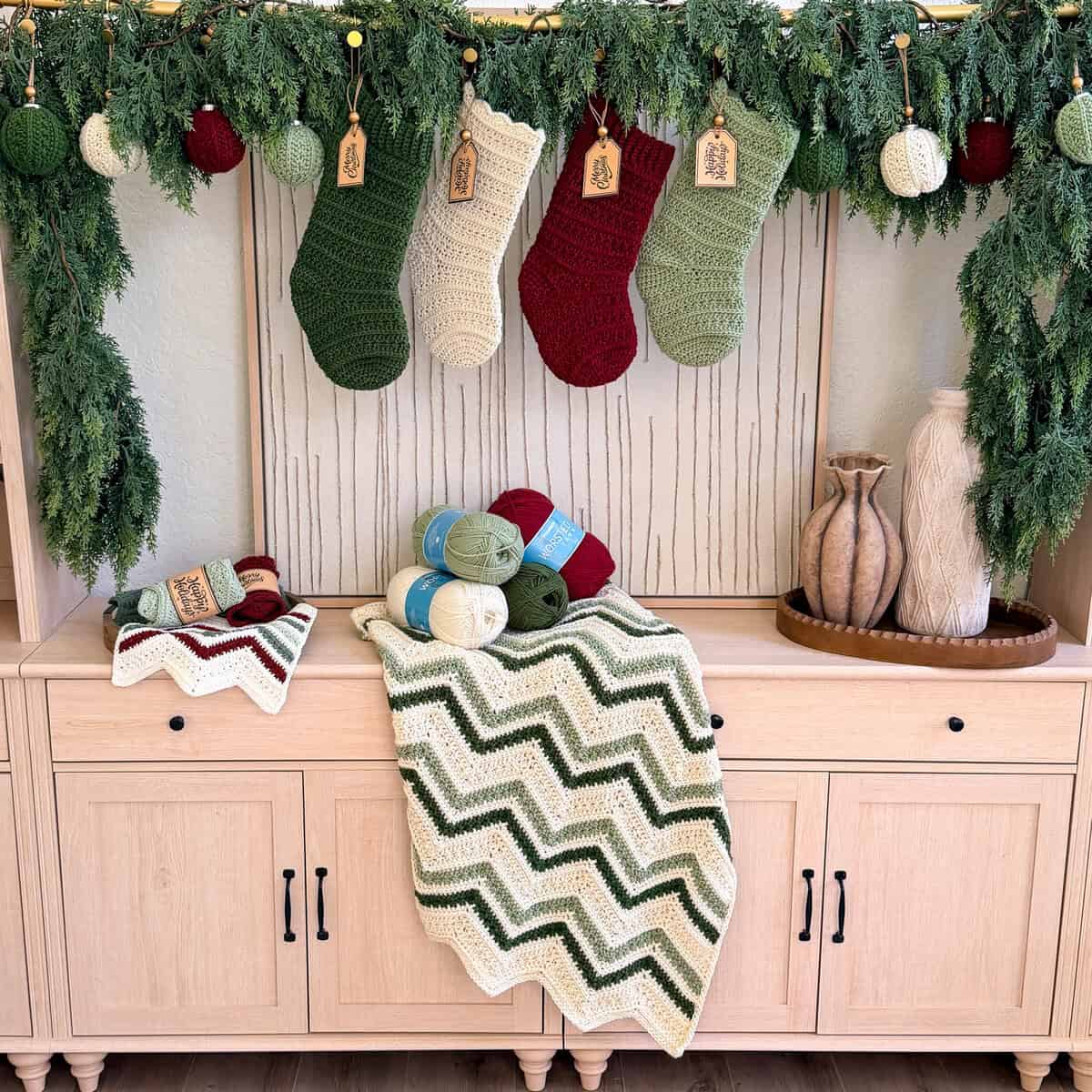 Briana standing beside a mantel styled with the Petal Loop crochet collection