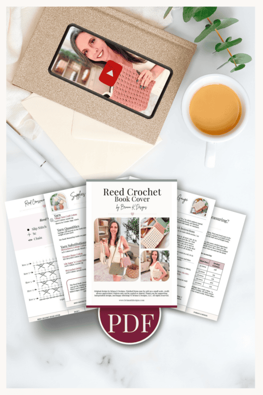 Flat lay of a Reed Crochet Book Cover PDF pattern, crochet sample images, a cup of tea, a pen, and an envelope with a photo of a woman holding a crocheted book cover.
