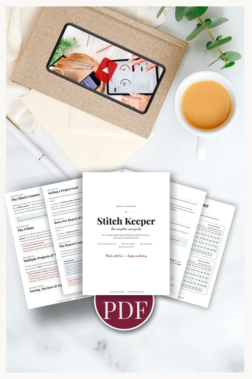 Flat lay of a tablet, coffee, envelope, plant, and printed knitting guide pages titled “Stitch Keeper,” with a circular PDF icon at the bottom center—perfect for organizing your patterns with the included free stitch counter.