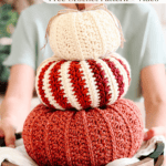 A person holds a wooden tray with three crocheted pumpkins stacked on top of each other; text above offers a free crochet pattern and video.