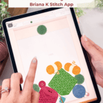 A hand touches a tablet screen displaying a yarn-themed crochet game. Text above promotes a free game called Wind Up, available on a blog and in the Briana K Stitch App.