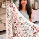 Woman holding a crocheted blanket with colorful flower motifs, standing in a living room. Text on image reads “Blossom Square Blanket: Free Pattern + Video Tutorial.”.