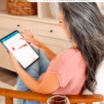 Woman with gray hair sits in a chair using a tablet. A small table in the foreground has a knitted jar cover and a flower, adding a cozy touch reminiscent of crochet. Text overlay advertises Briana K’s Loose Ends free solitaire game.