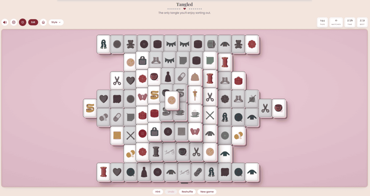 Tangled crochet matching game board with yarn balls, sweaters, sheep and teacup tiles