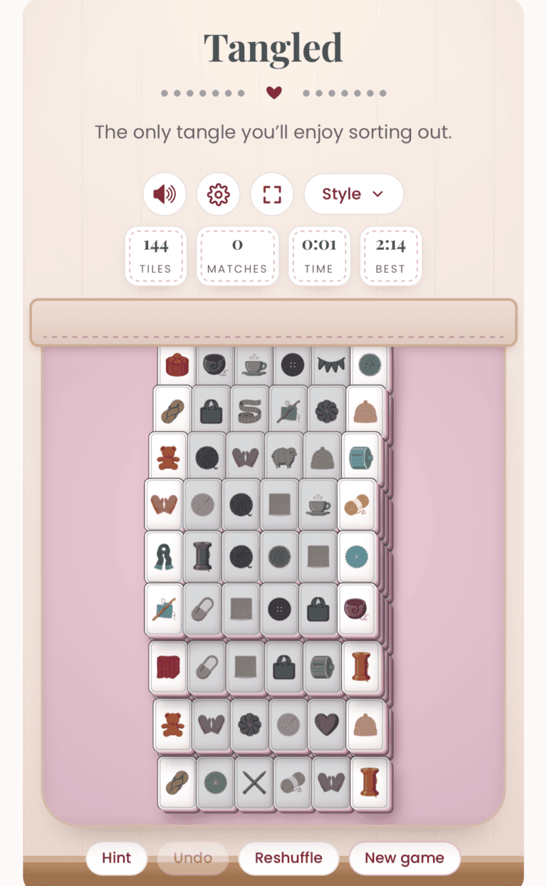 A digital tile-matching game called “Tangled” is in progress, showing stacked tiles with sewing-themed icons and game stats above, evoking the charm of a crochet solitaire game.